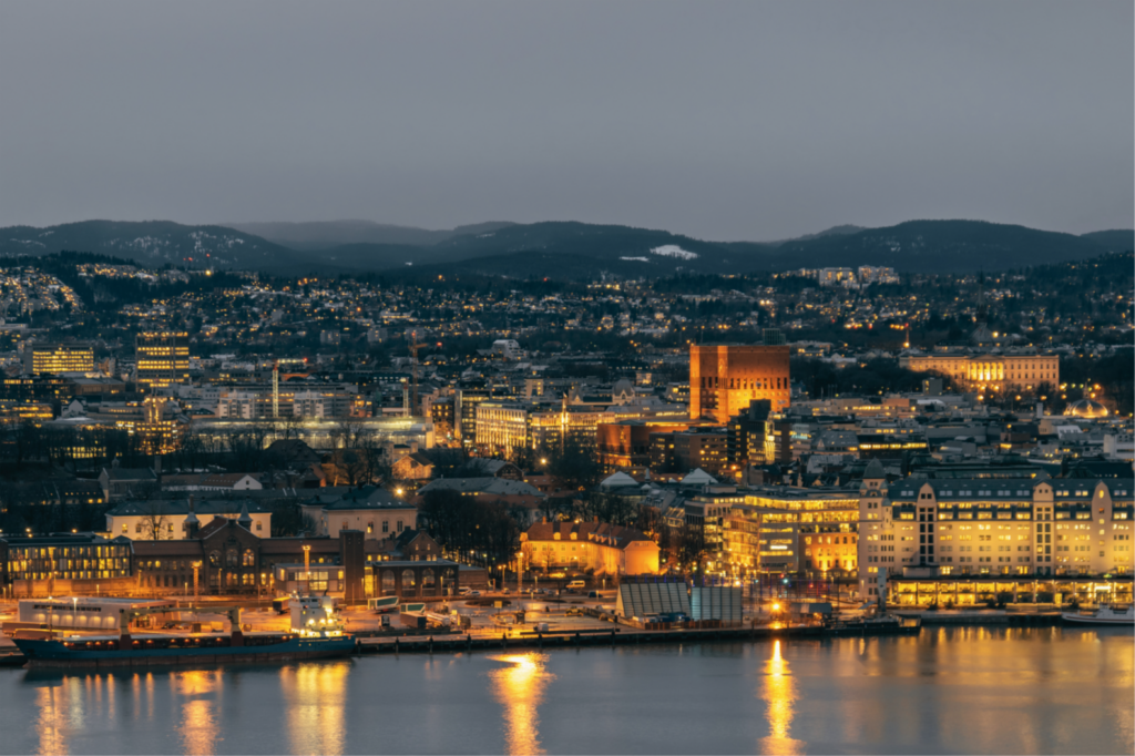 Oslo luxury travel city skyline at dusk with waterfront reflections and illuminated architecture